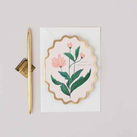 Decorative card with floral design and gold pen on a light gray background