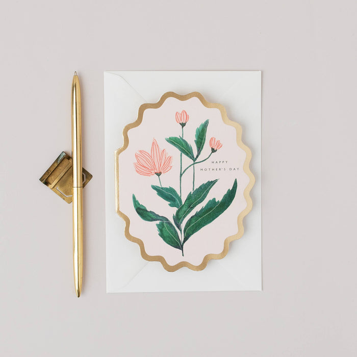 Decorative card with floral design and gold pen on a light gray background