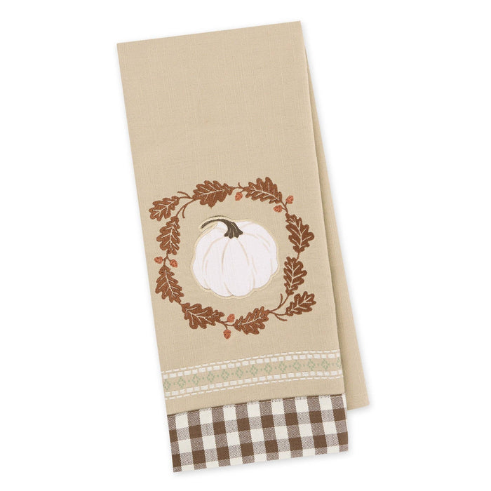A beige kitchen towel featuring a white pumpkin inside a brown leaf wreath, with a brown and white gingham check border at the bottom, shown on a plain white background.