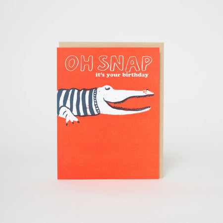Greeting card with a crocodile illustration and 'OH SNAP it's your birthday' text on an orange background.