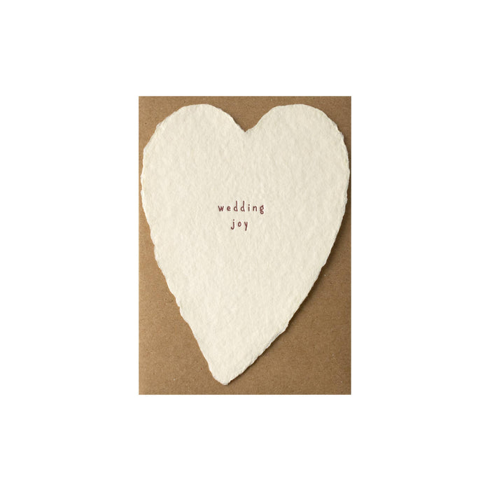 Heart-shaped card with 'wedding joy' text on a brown background