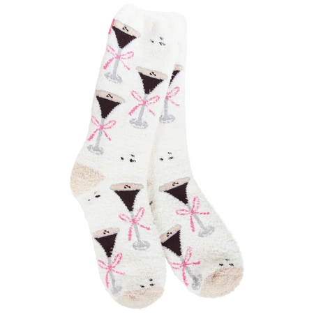 A pair of white fuzzy crew socks with a repeating pattern of martini glasses filled with dark liquor and tied with pink bows, shown on a plain white background.