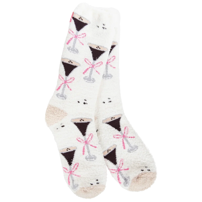 A pair of white fuzzy crew socks with a repeating pattern of martini glasses filled with dark liquor and tied with pink bows, shown on a plain white background.