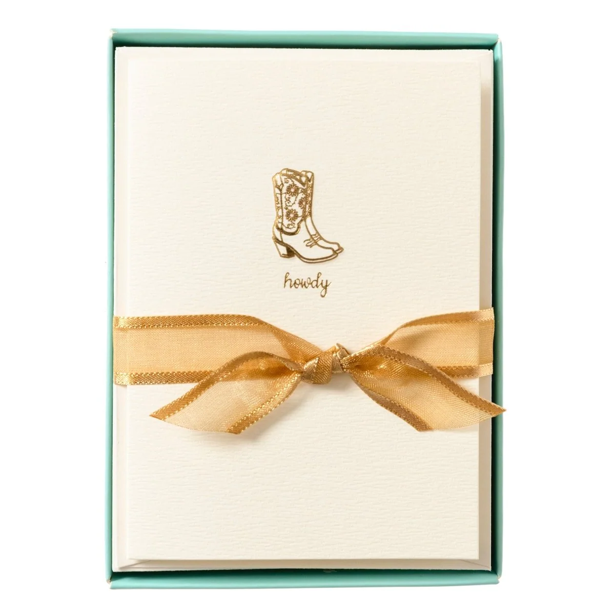 Set of tan notecards with a gold gilded cowgirl boots design in a teal box with a gold ribbon.