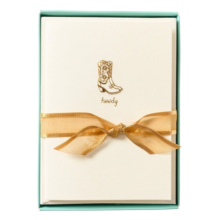 Set of tan notecards with a gold gilded cowgirl boots design in a teal box with a gold ribbon.