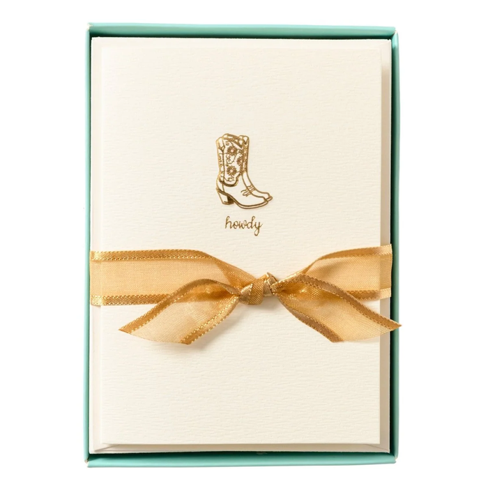 Set of tan notecards with a gold gilded cowgirl boots design in a teal box with a gold ribbon.
