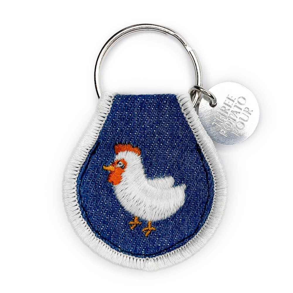 Keychain with embroidered chicken design on a blue background