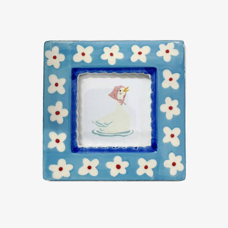 Decorative square frame with floral border and central illustration on a white background
