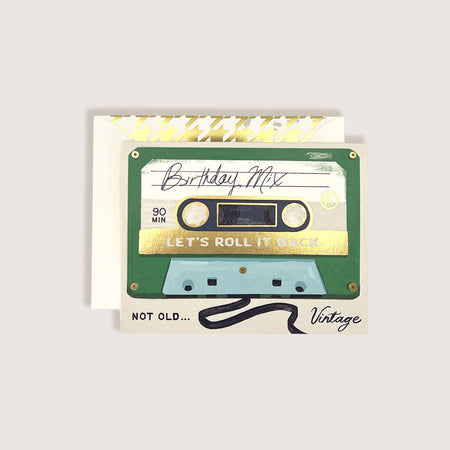 Cassette tape-themed birthday card with decorative elements on a light gray background