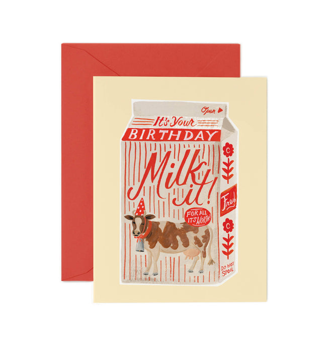 Birthday card with a milk carton design featuring a cow, on a beige card with a red envelope.