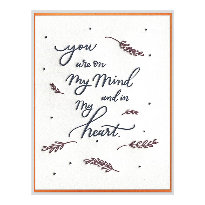 Card with text 'You are on my mind and in my heart' and decorative elements on a white background.