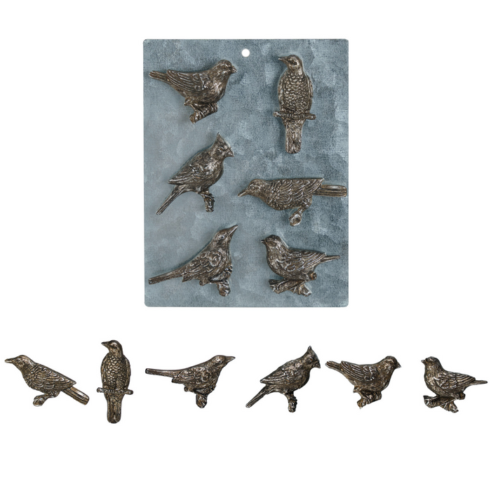 Bronze bird figurines on a textured blue background