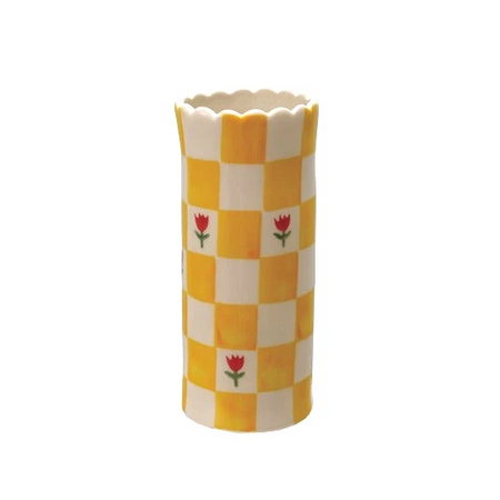 Decorative vase with yellow and white checkered pattern and red flower design on a white background