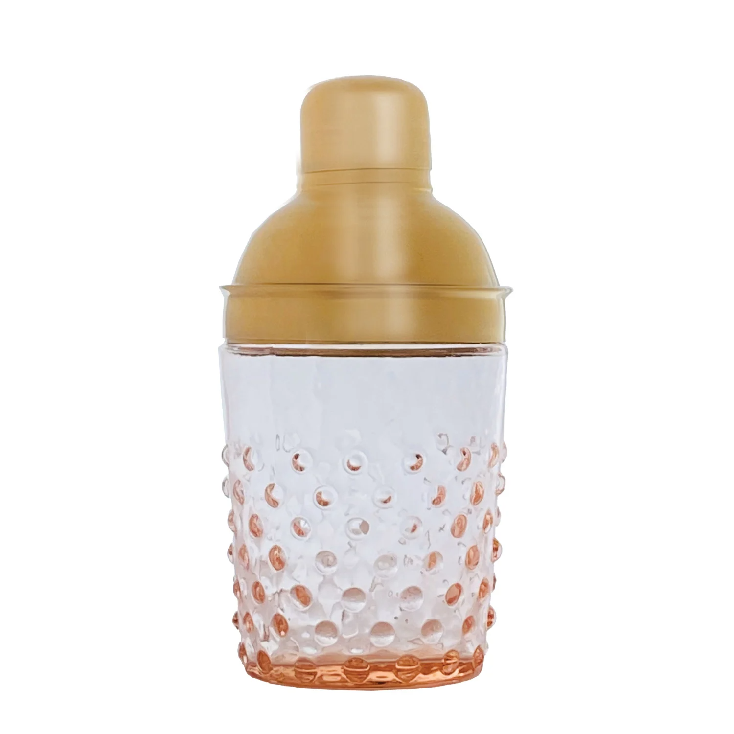 A cocktail shaker with a translucent clear glass body featuring a textured bubble pattern that fades into a warm peach-orange at the bottom, topped with a metallic gold screw-on lid.