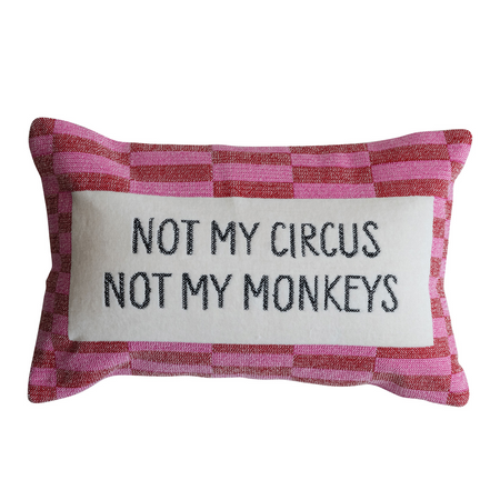 Checkered pillow with 'Not my circus, not my monkeys' text on a white background