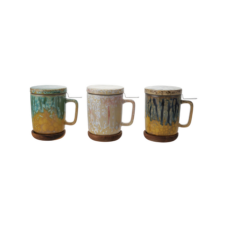 Three ceramic mugs with unique designs on a white background