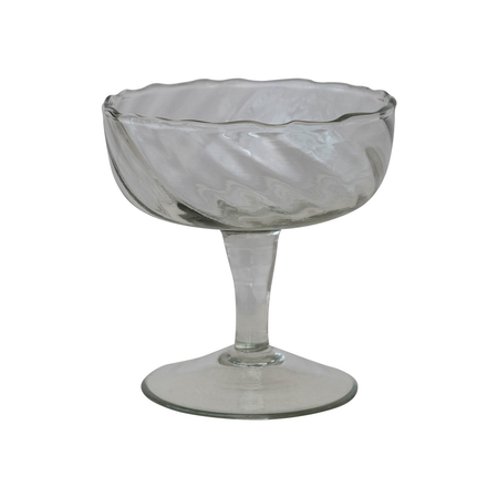 Clear glass footed coupe glass on a white background