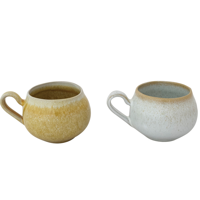 Two ceramic mugs, one yellow and one white with brown rim, on a white background.