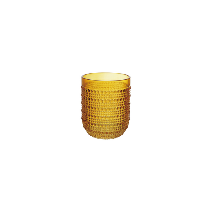 A textured amber yellow glass tumbler with a dimpled, honeycomb-like pattern, shown on a solid white background.