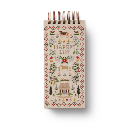Small notebook with decorative cover and 'Market List' text on a white background