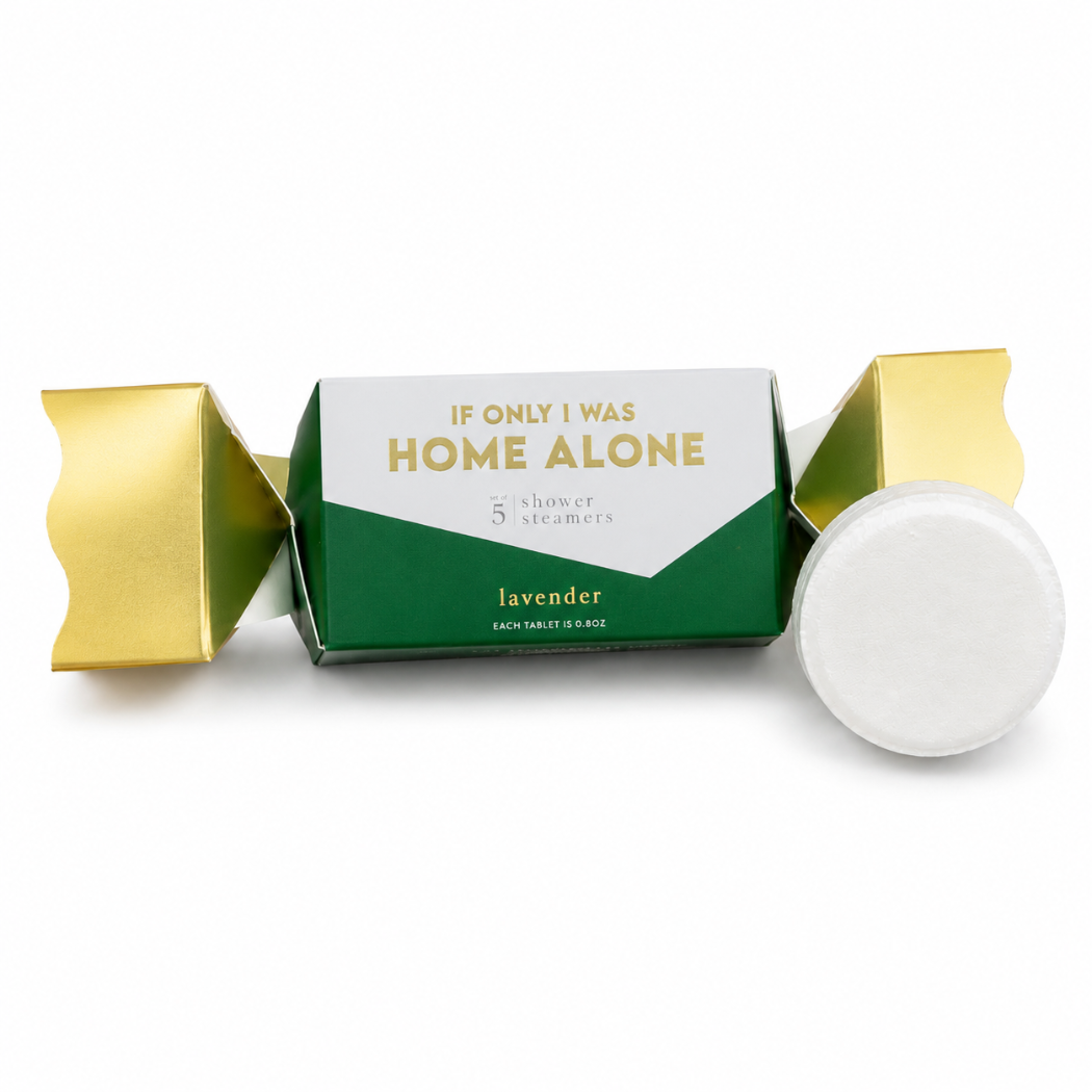 A packaged lavender home fragrance product on a white background. The box is green and white with gold text reading 'IF ONLY I WAS HOME ALONE' and 'lavender,' with gold wrapper tabs on both sides and a round white disc placed in front.