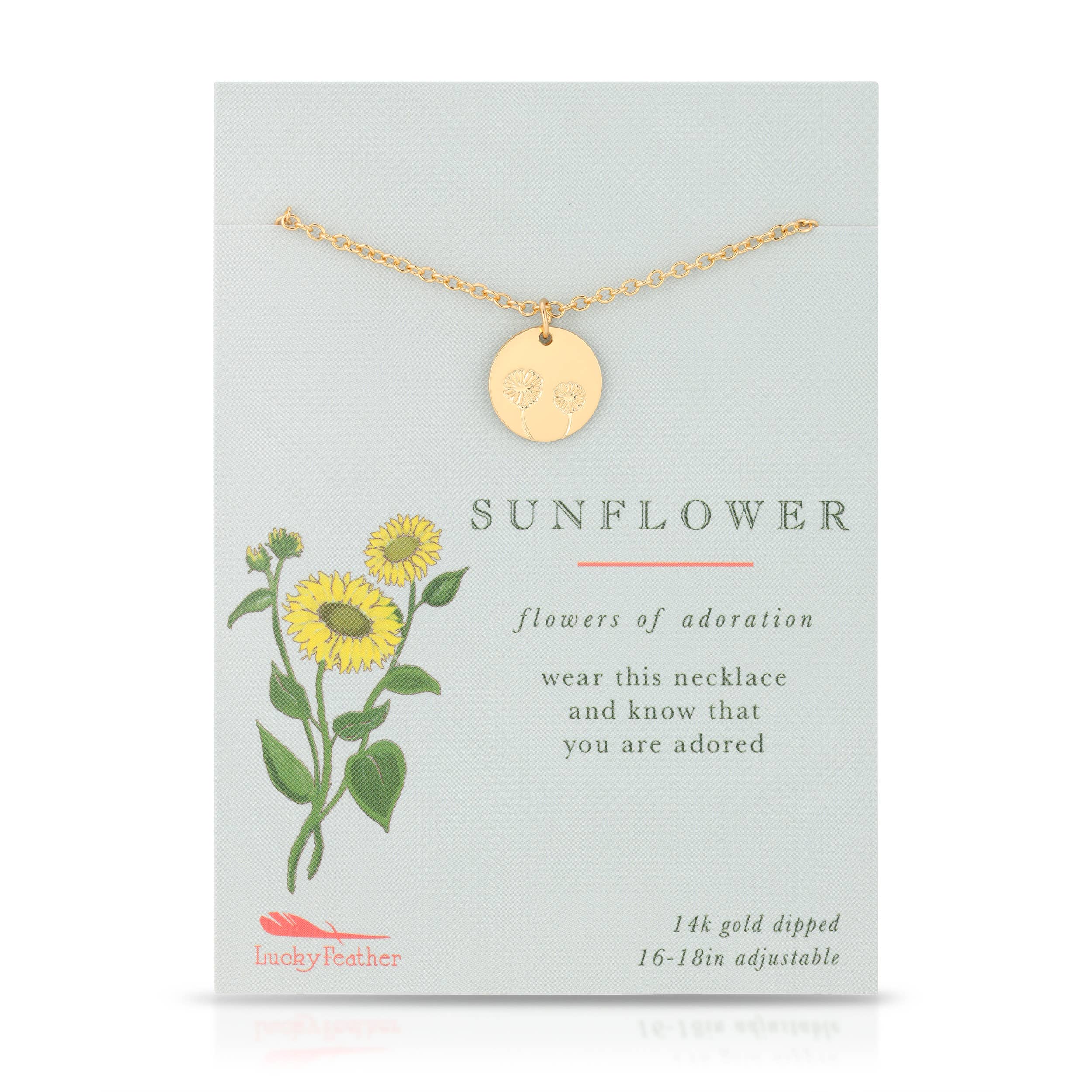 Gold necklace with a round pendant on a card featuring sunflower illustrations and text.