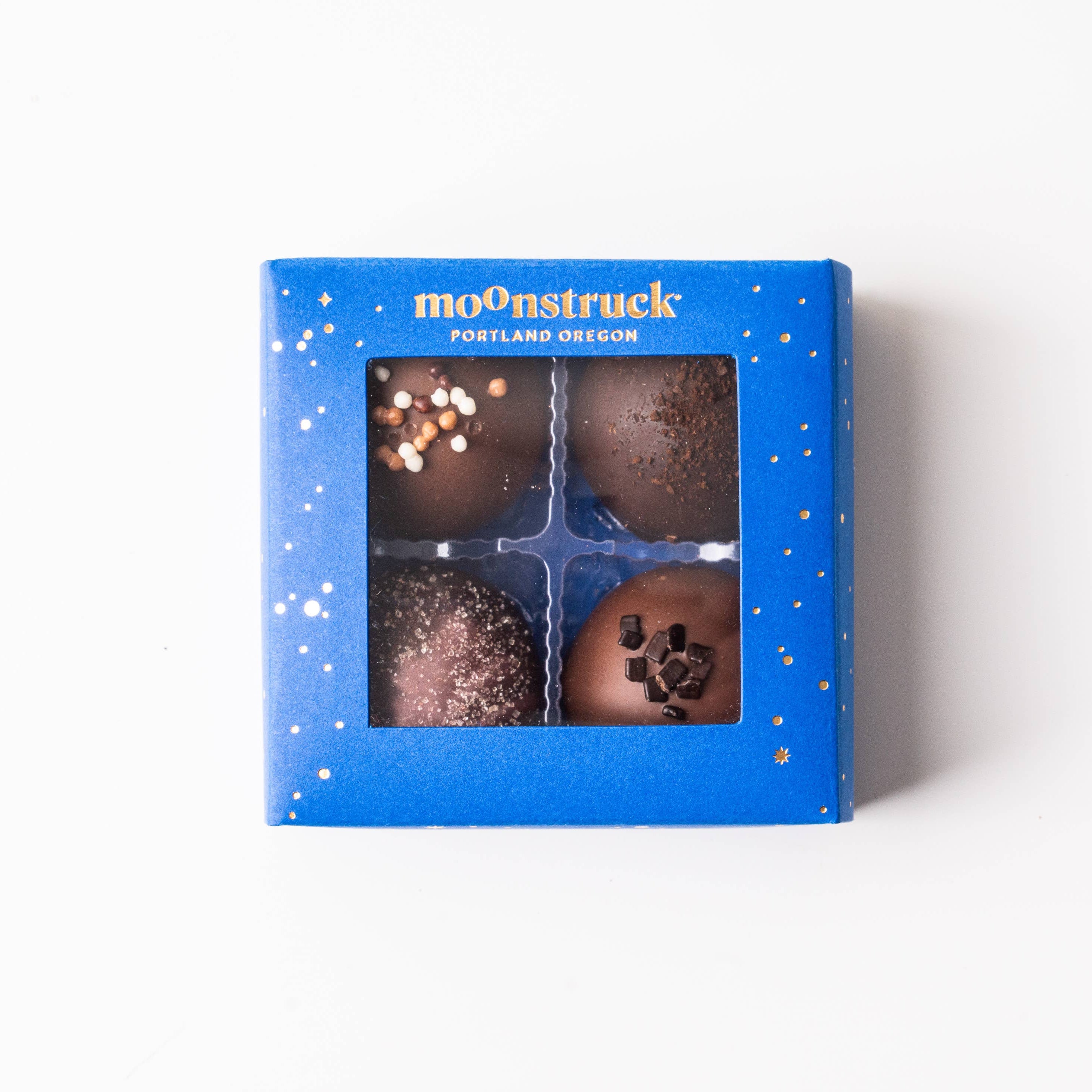 Box of chocolate truffles with 'moonstruck' branding on a white background