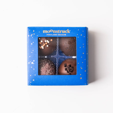 Box of chocolate truffles with 'moonstruck' branding on a white background
