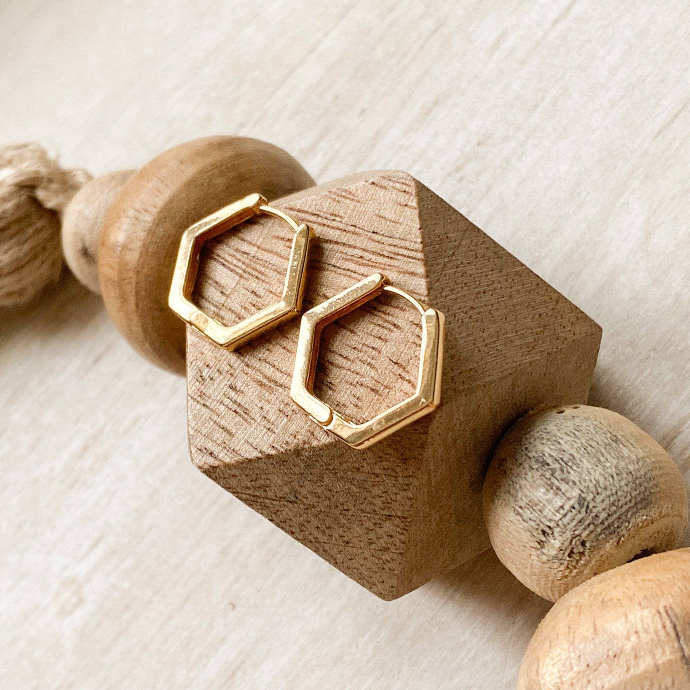 Wooden toy with gold geometric design on a light background