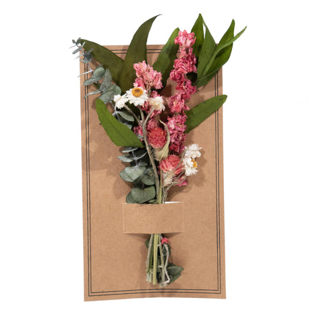 Floral arrangement on a cardboard base with a white background