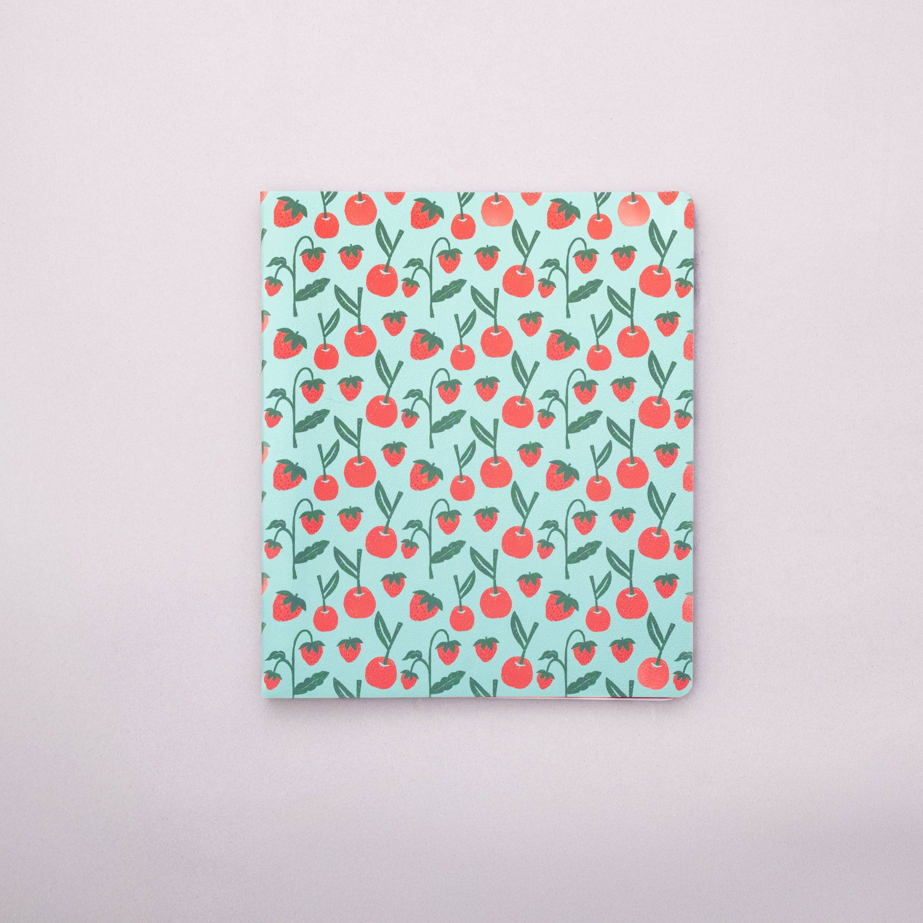 Notebook with cherry pattern on a light gray background