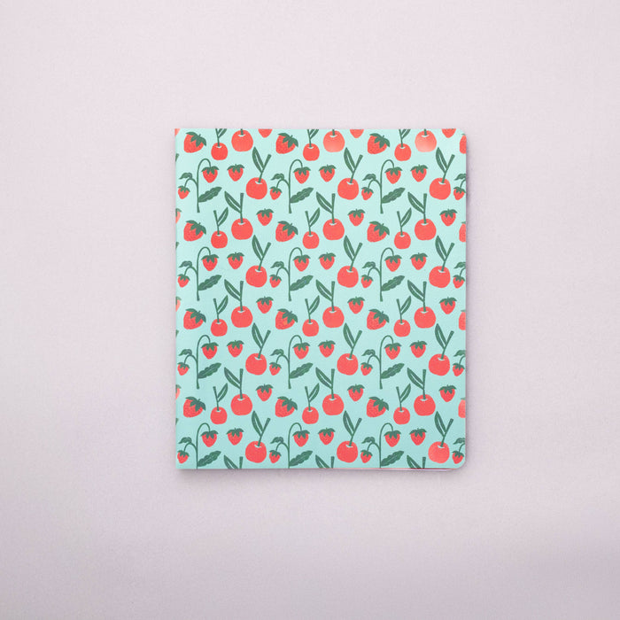 Notebook with cherry pattern on a light gray background