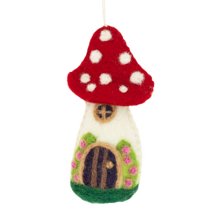 Felted fairy house ornament with red mushroom cap on a white background