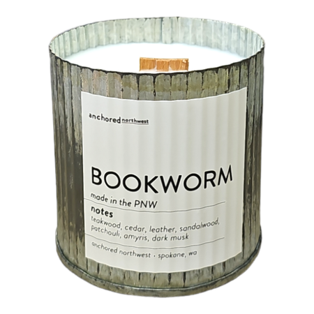 Candle with a label titled 'Bookworm' from Anchored Northwest on a white background