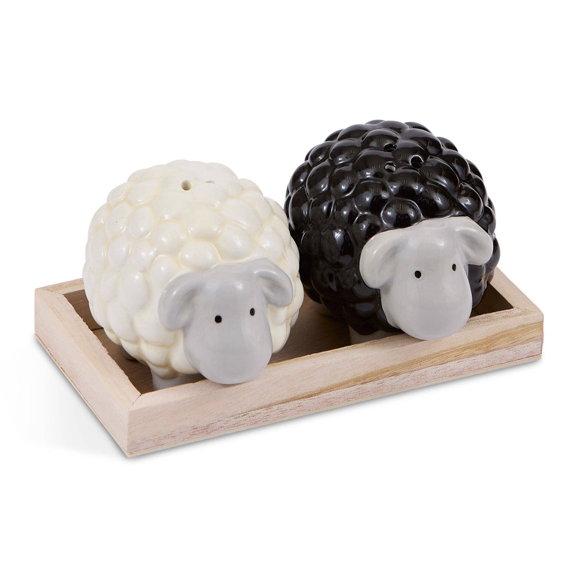 Sheep-shaped salt and pepper shakers on a wooden base with a white background