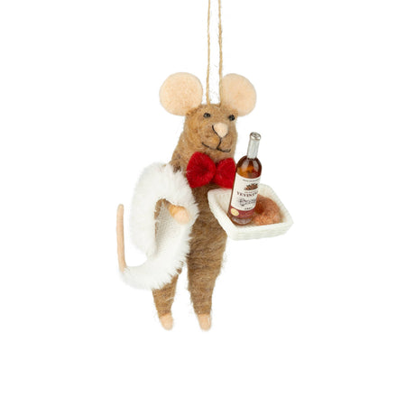 Decorative mouse ornament holding a bottle and a plate on a white background