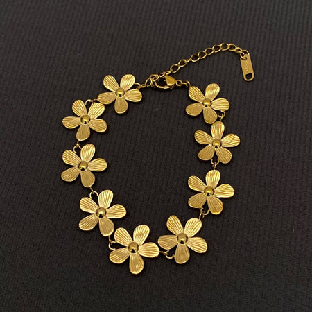 Gold floral bracelet on a black background