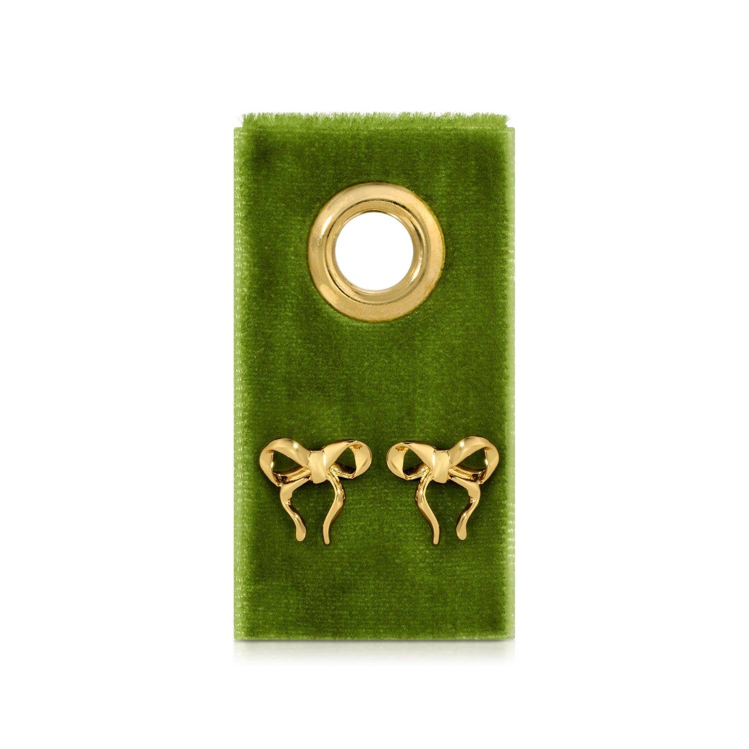 Gold bow-shaped earrings on a green velvet card 