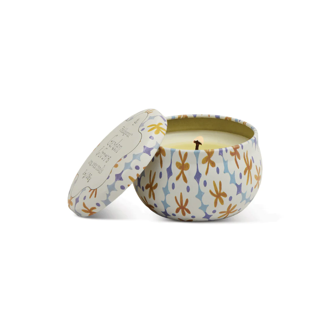 Decorative candle in a patterned container on a white background