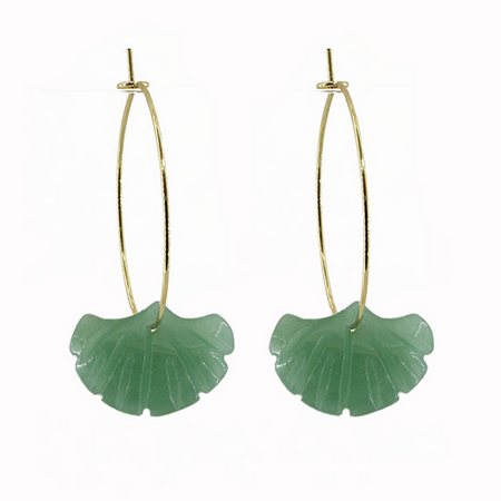 Green leaf-shaped earrings on gold hoop wires against a white background