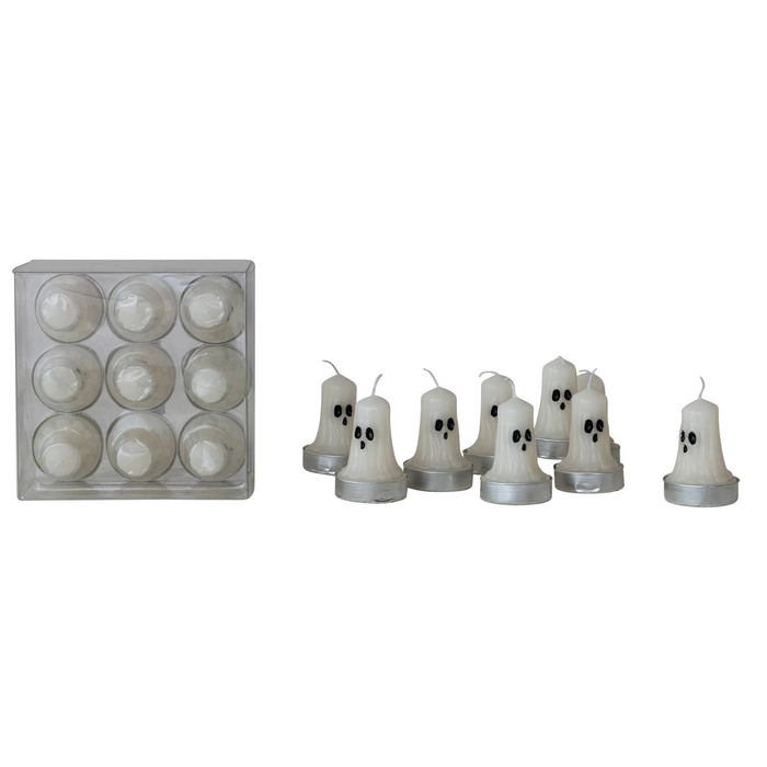 A set of ghost-shaped tea light candles with black facial features, shown alongside their clear plastic storage container on a plain white background.