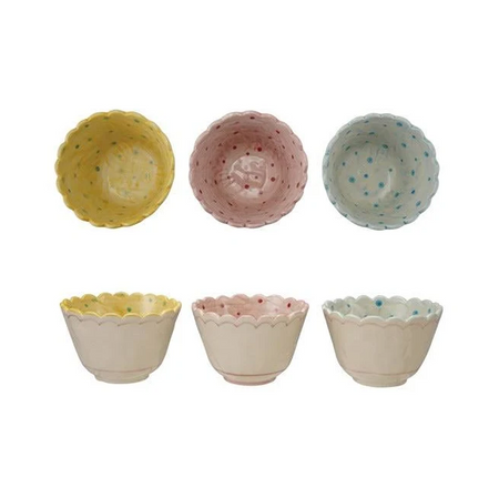 Small ceramic bowls in pastel colors with decorative rims on a white background.