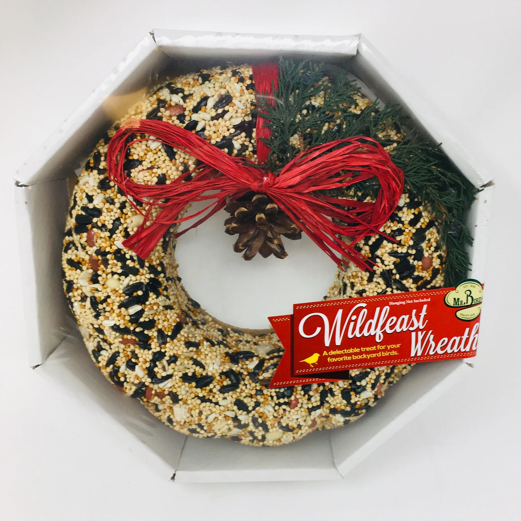 A solid seed, nut, and fruit wreath presented in a shrink-wrapped tray with a red ribbon bow and pine cones. The wreath is adorned with a red bow and green pine cones.