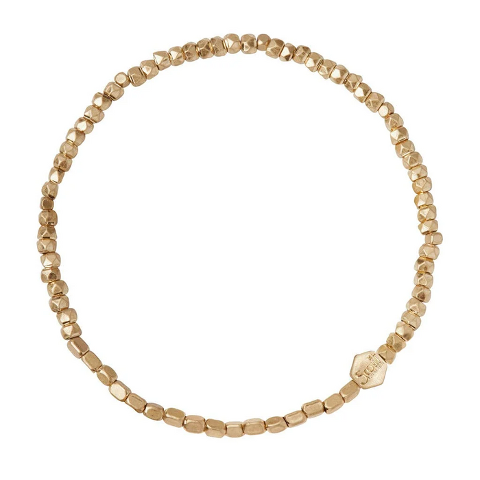 Gold beaded bracelet on a white background