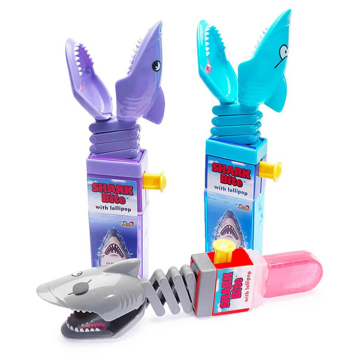 Shark Bite toy with lollipop and packaging on a white background