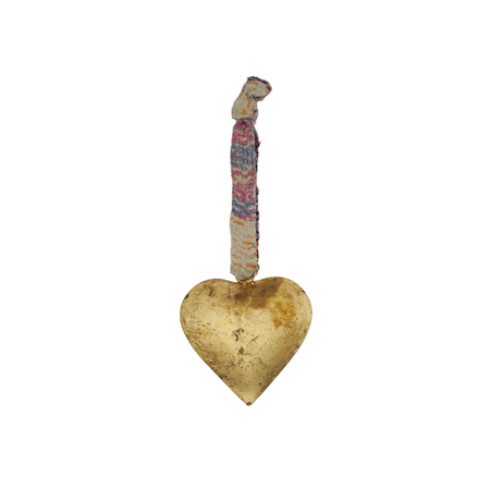 Decorative heart-shaped brass ornament with a colorful ribbon on a white background