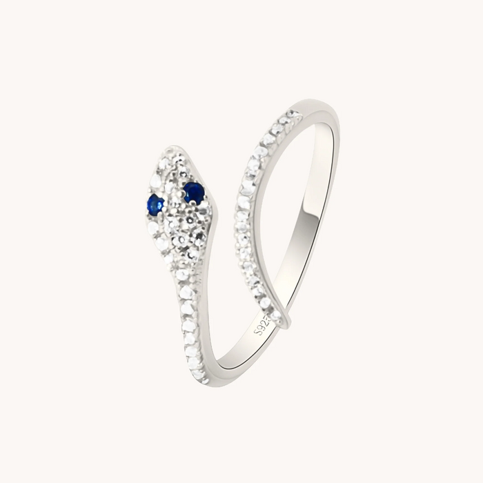 Silver snake ring with blue crystals as eyes