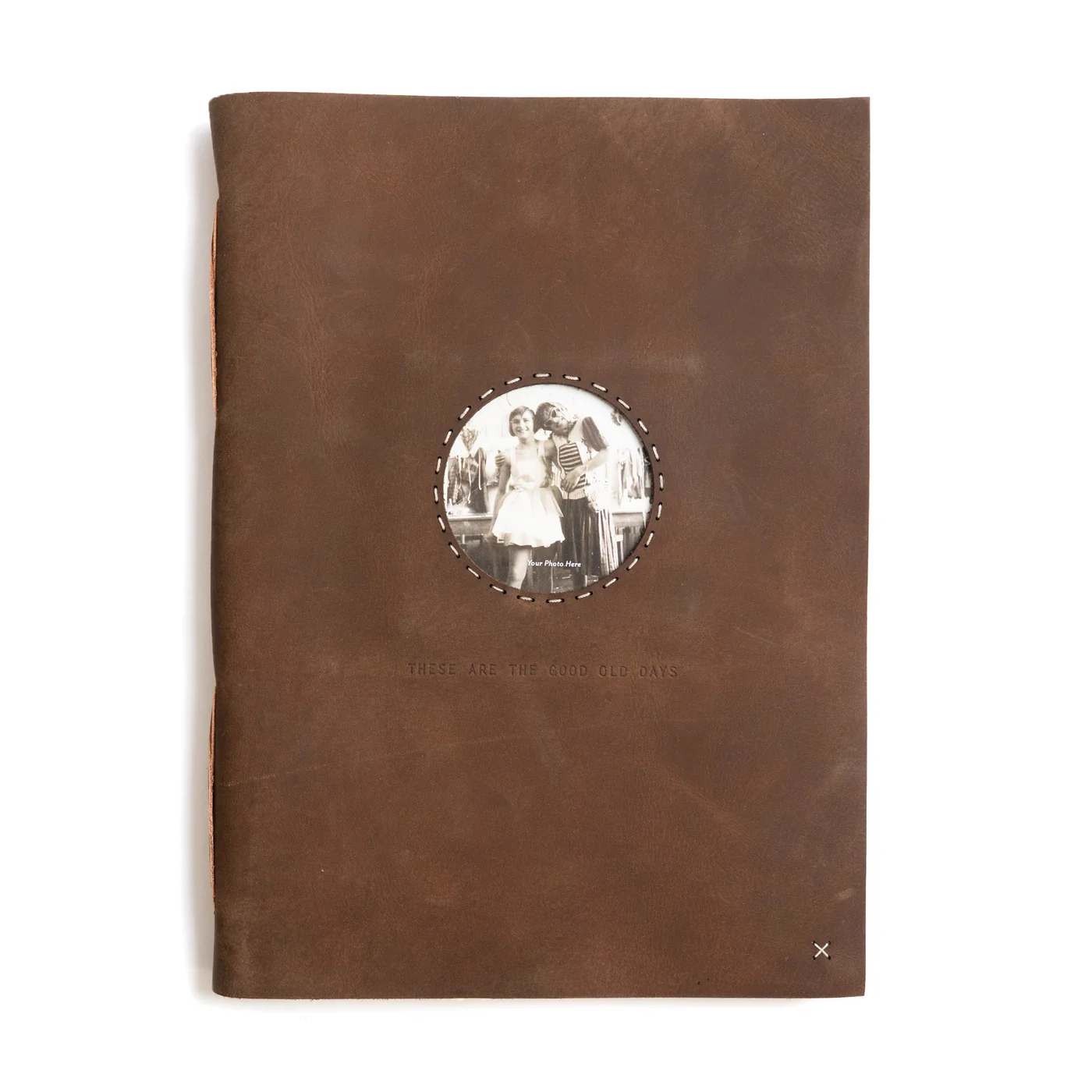 Brown leather-bound book with a circular photo holder on the cover