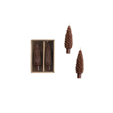 set of two pinecone shaped candles in cardboard box on white background