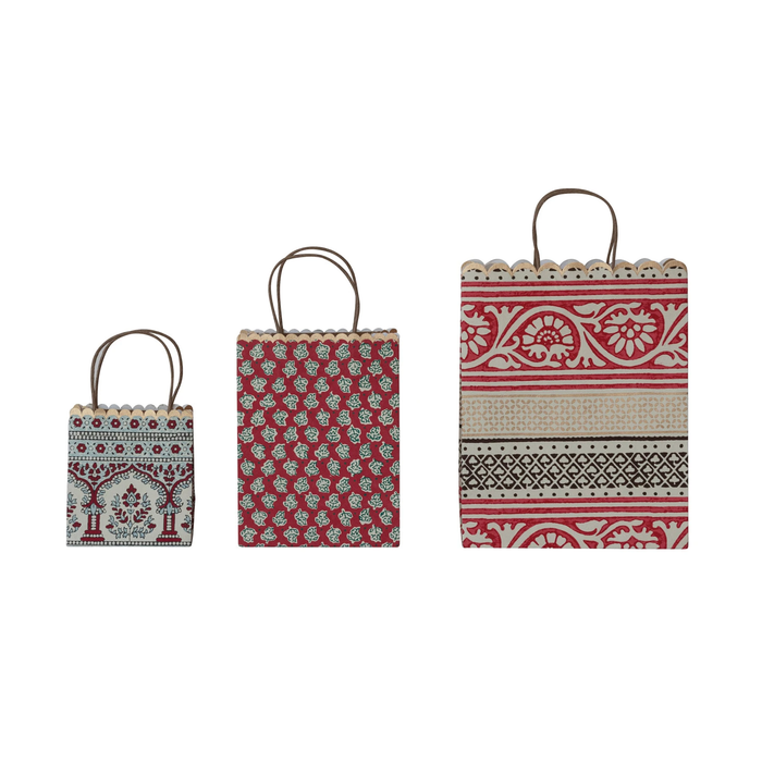 Three gift bags with a scalloped top edge and vintage green, red, and beige patterns.